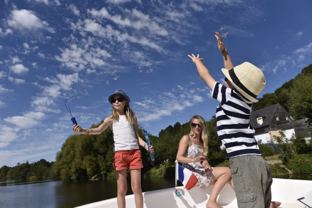 Family is playing during holiday on a boat